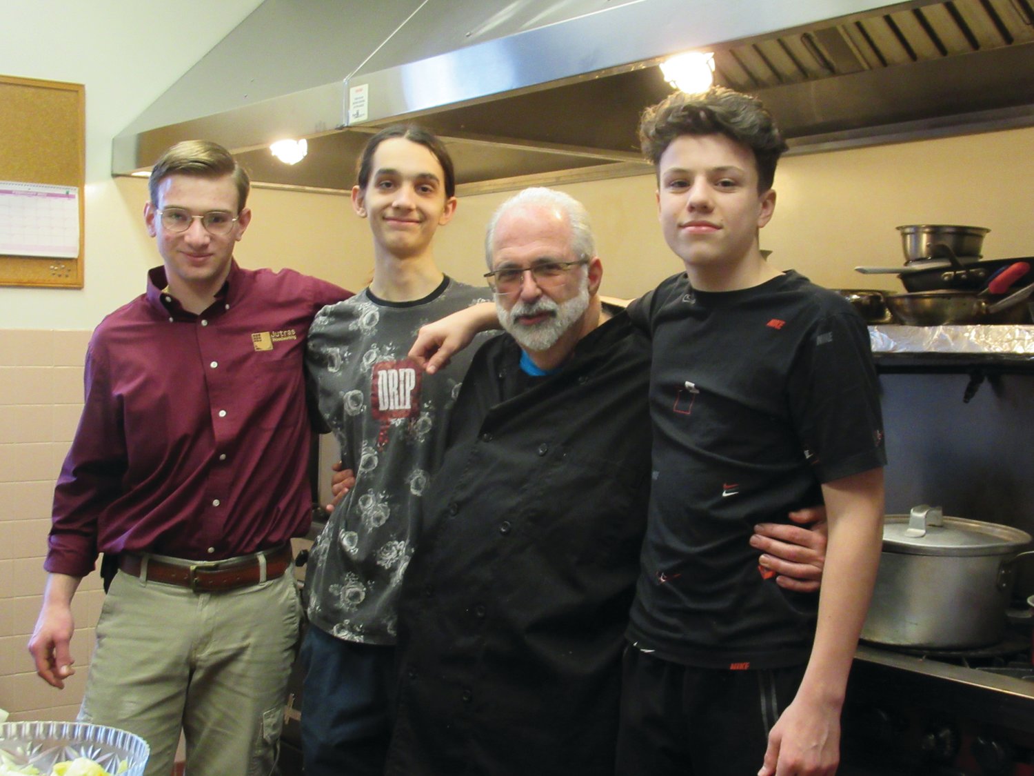 HELPING HANDS: OLG Chef Mike Lombardi is joined by members of the parish’s confirmation class who performed many duties in and out of the kitchen during Saturday’s St. Joseph’s Day Party.
